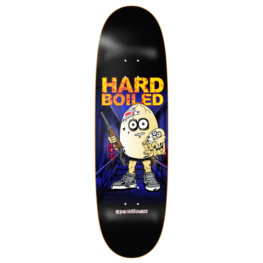A skateboard deck shown from the top side against a plain white background. The deck has a black base with a colorful graphic featuring a cartoon potato character holding a gun, with the text 'HARD BOILED' in yellow and orange above it.