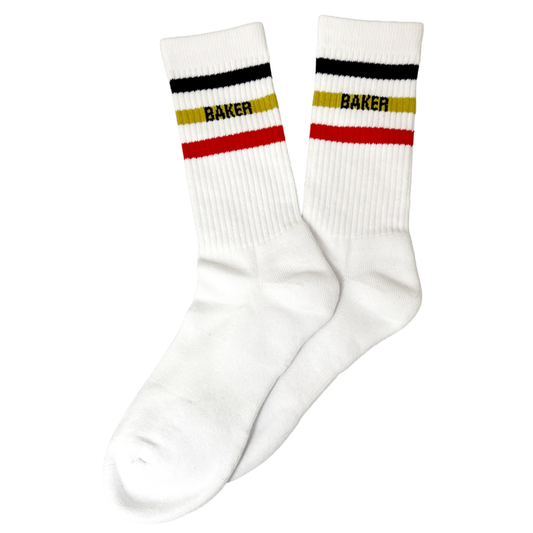 A pair of white crew socks with horizontal stripes in black, yellow, and red at the ribbed cuff, featuring the word 'BAKER' printed in black across the yellow stripe.