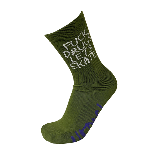 An olive green crew sock with white text reading 'FUCK DRUGS LET'S SKATE' on the side and purple text on the sole, shown against a plain white background.
