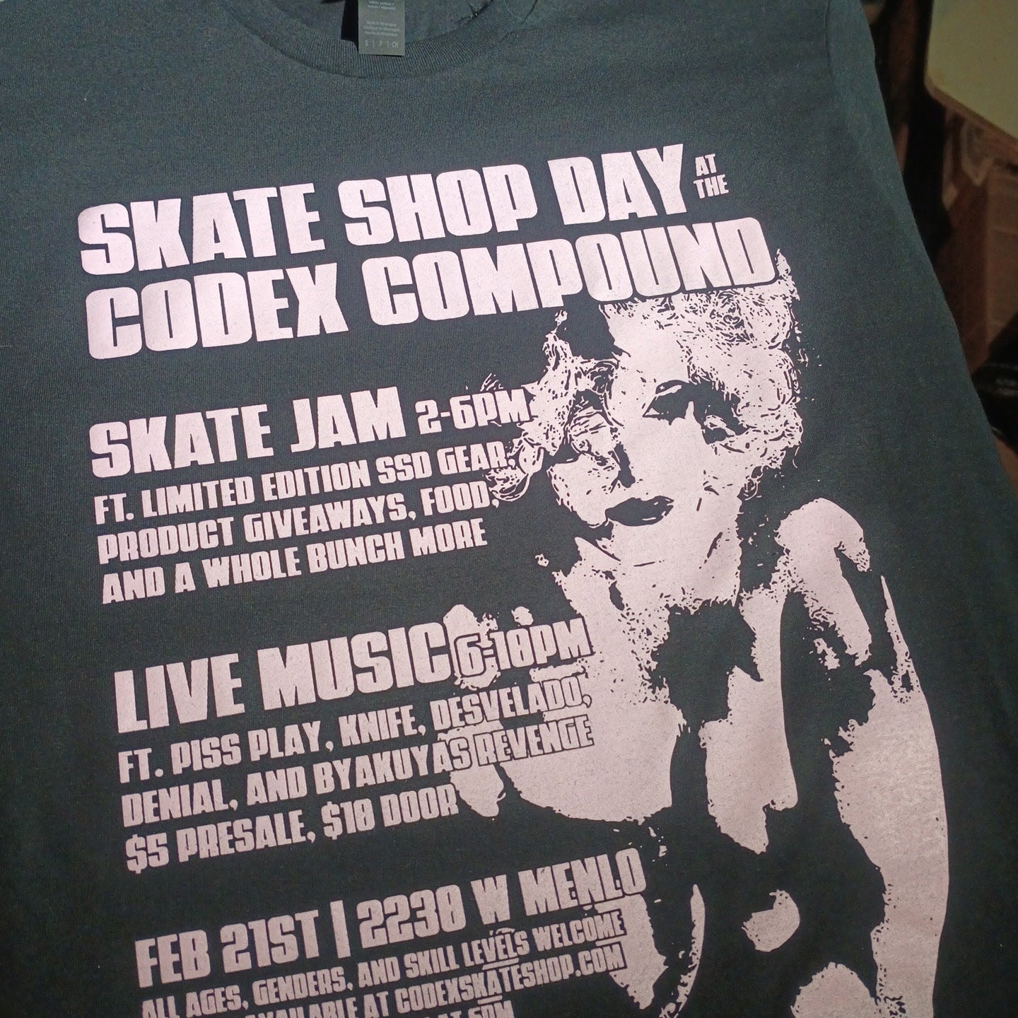 Black t-shirt with white text and graphic design on a table