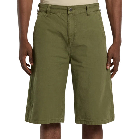 Green shorts worn by a person on a white background