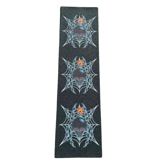 A long rectangular black grip tape strip featuring three vertical rows of a spiderweb design surrounding a skull with red eyes and a small orange star detail.