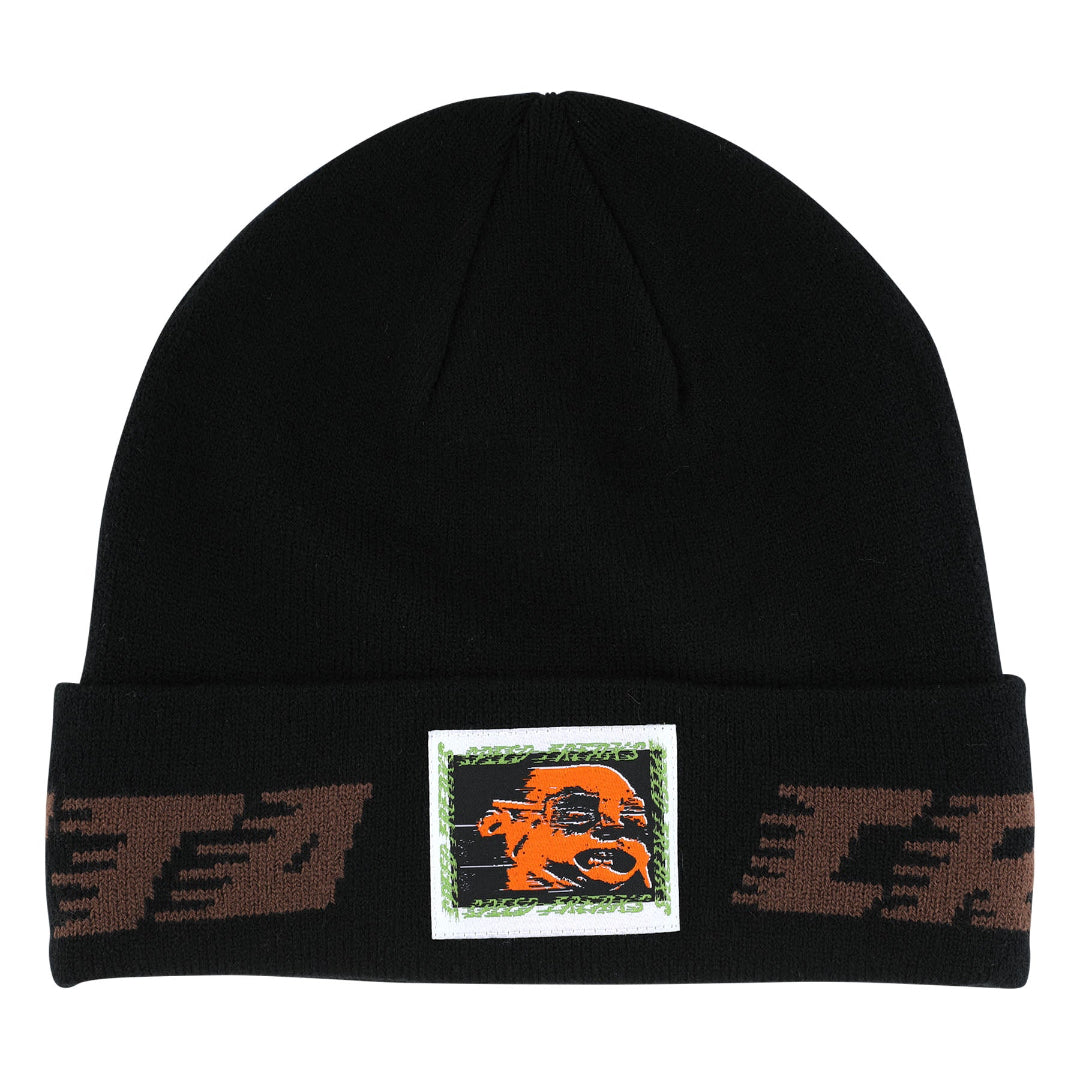 A black knit beanie hat featuring a folded cuff with brown patterned side details and a central square patch containing an orange graphic on a white background.