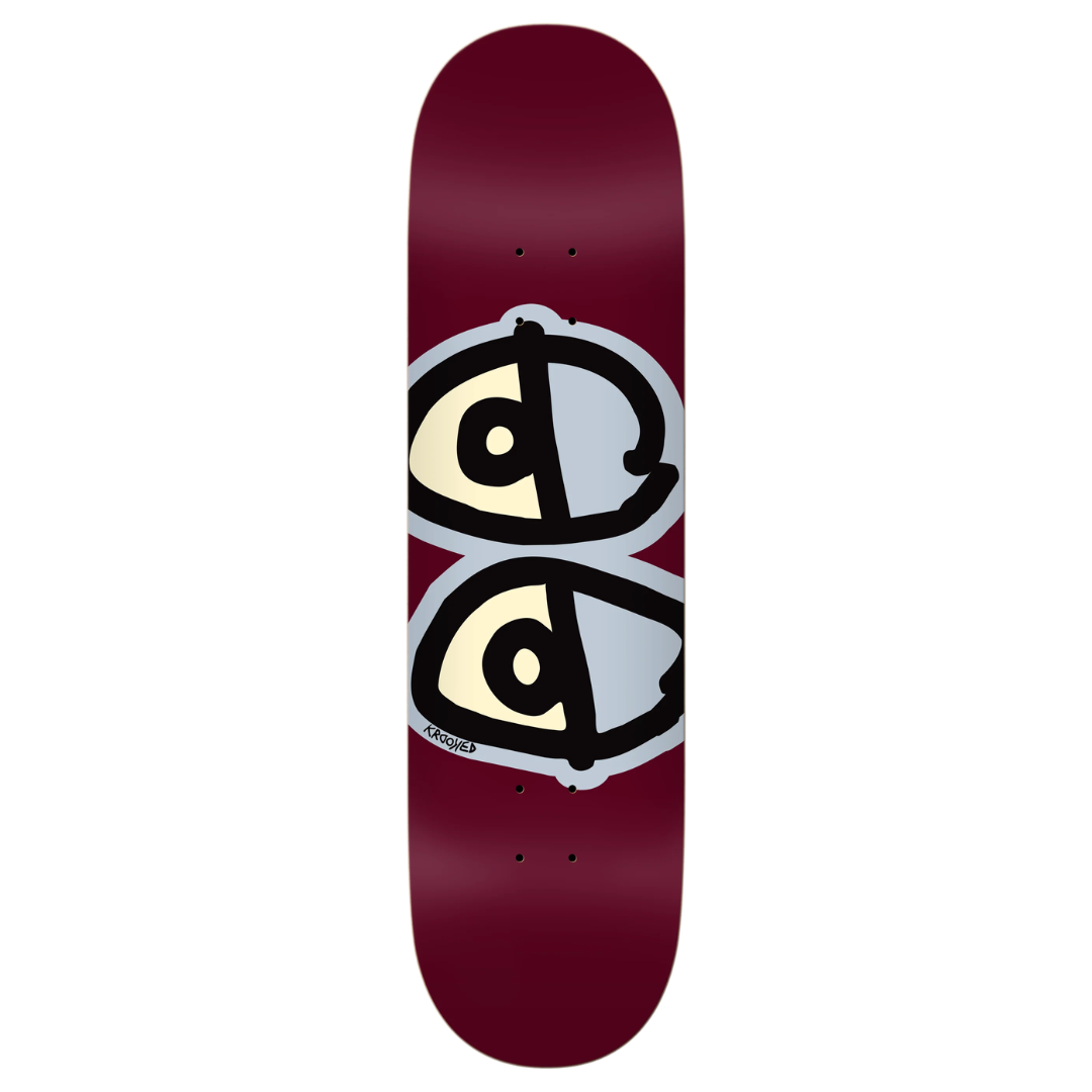 A skateboard deck with a deep burgundy background, featuring a graphic of two stylized eyes stacked vertically. The eyes are cream-colored with black outlines and a light gray shadow effect.