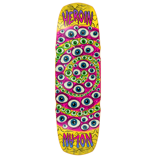 A long, narrow skateboard deck with a psychedelic design featuring a dense pattern of cartoon eyes in pink, green, blue, and white, set against yellow borders at the top and bottom. The words 'HEROIN' and 'NU-YON' are written in stylized purple and blue lettering on the yellow sections.