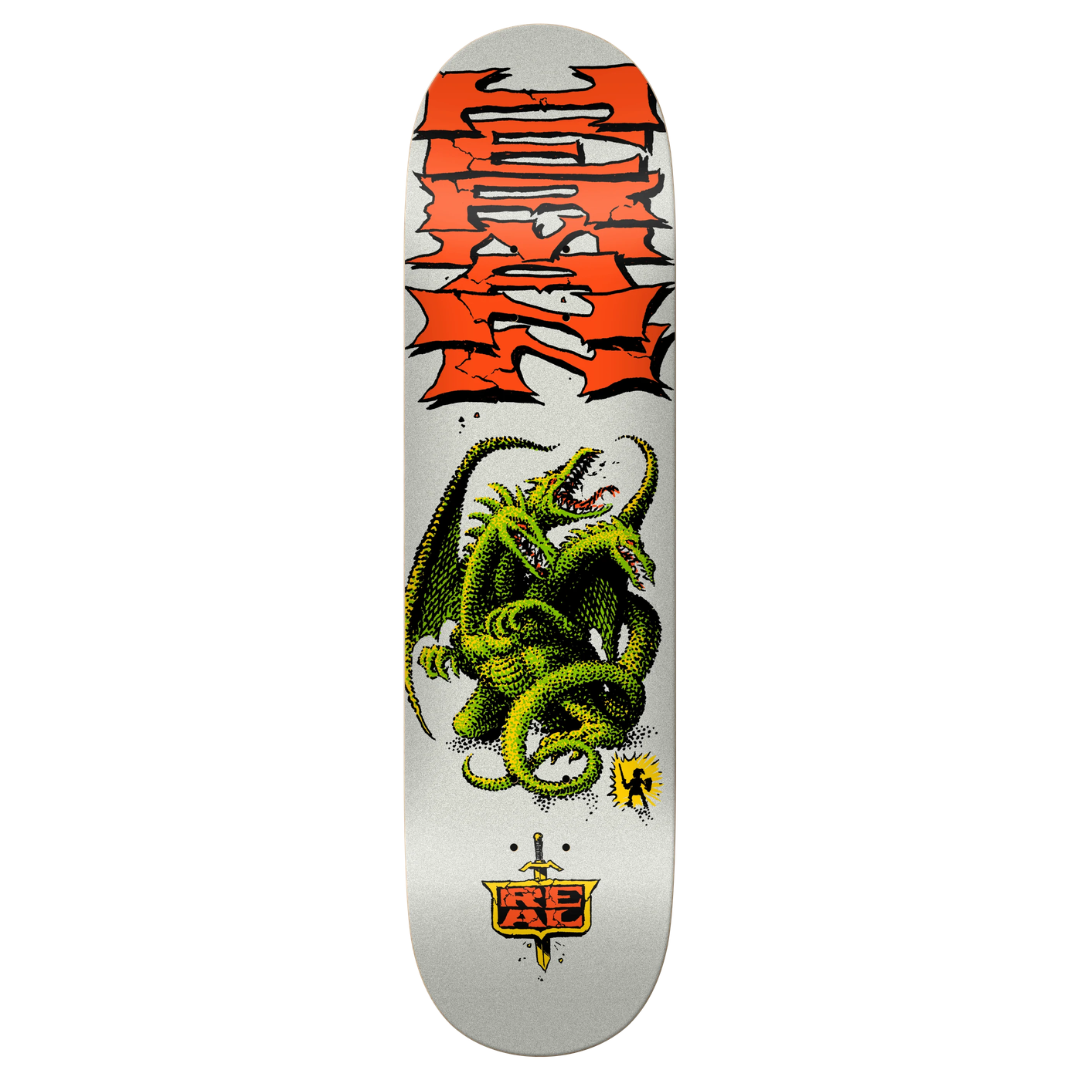 A skateboard deck shown vertically against a plain white background. The deck has a white base with a large orange and black graffiti-style graphic at the top, a green dragon illustration in the center, and a small orange and black logo near the bottom.
