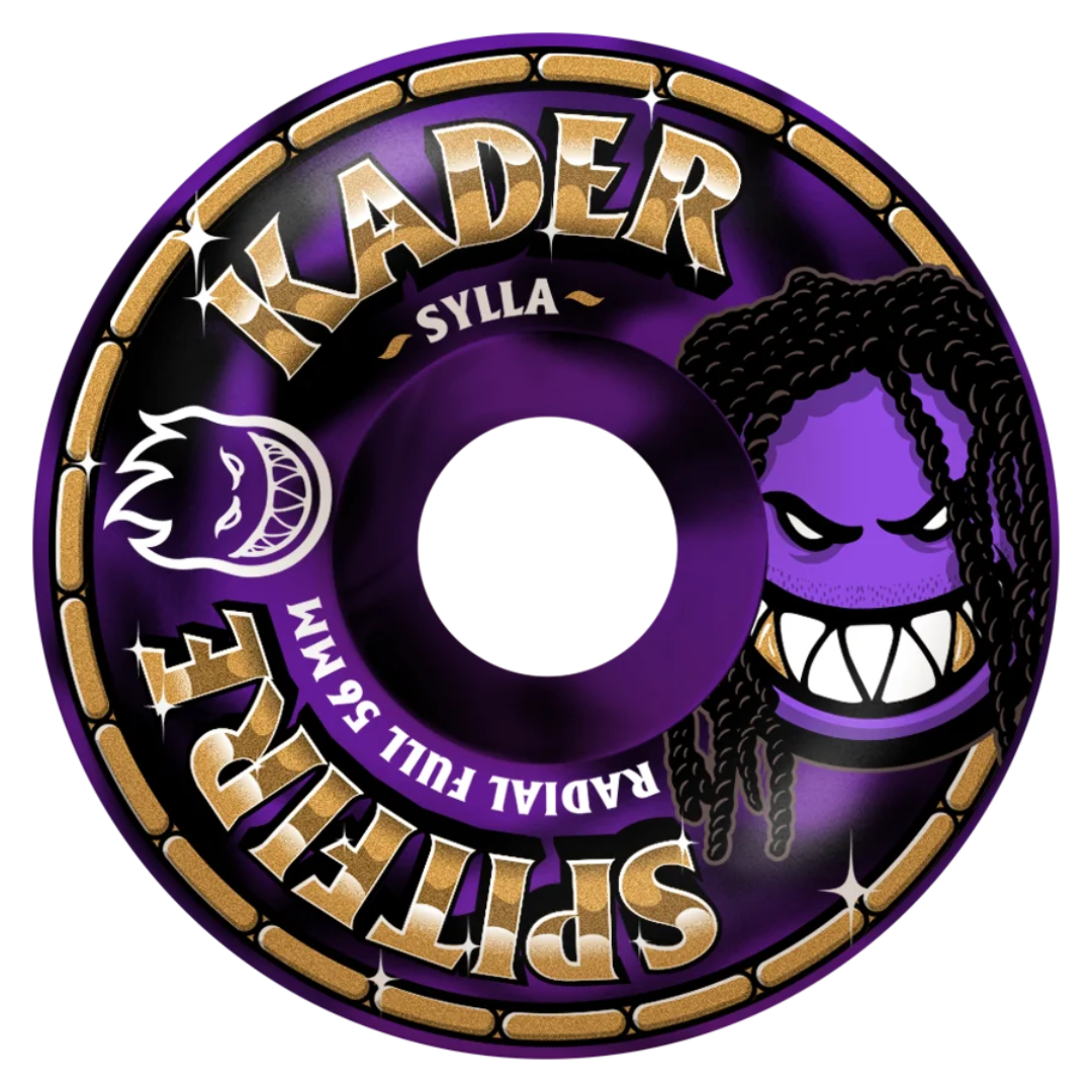 A single skateboard wheel shown on a plain white background. The wheel is predominantly purple with metallic gold lettering that reads 'KADER' and 'SPITAFRE', plus a stylized purple cartoon face graphic on the right side.