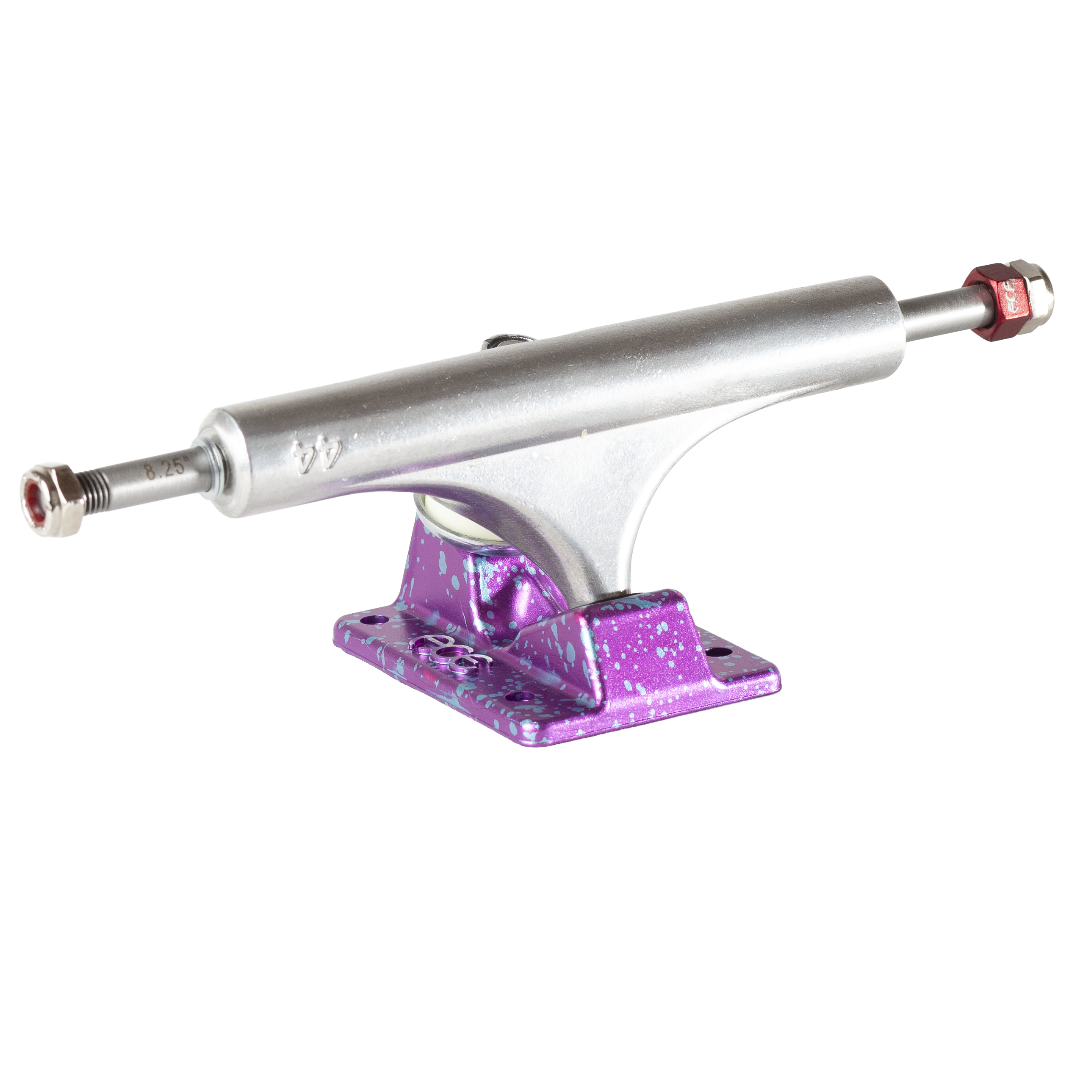 A single skateboard truck with a silver metal steerer and a purple glittery splatter-coated baseplate, shown on a plain white background.