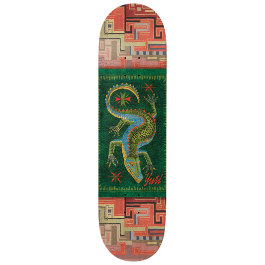 Skateboard deck with a colorful lizard design on a geometric patterned background