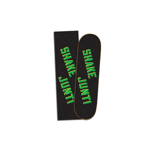 Black griptape with text reading "Shake Junt" in big stenciled green and yellow font.